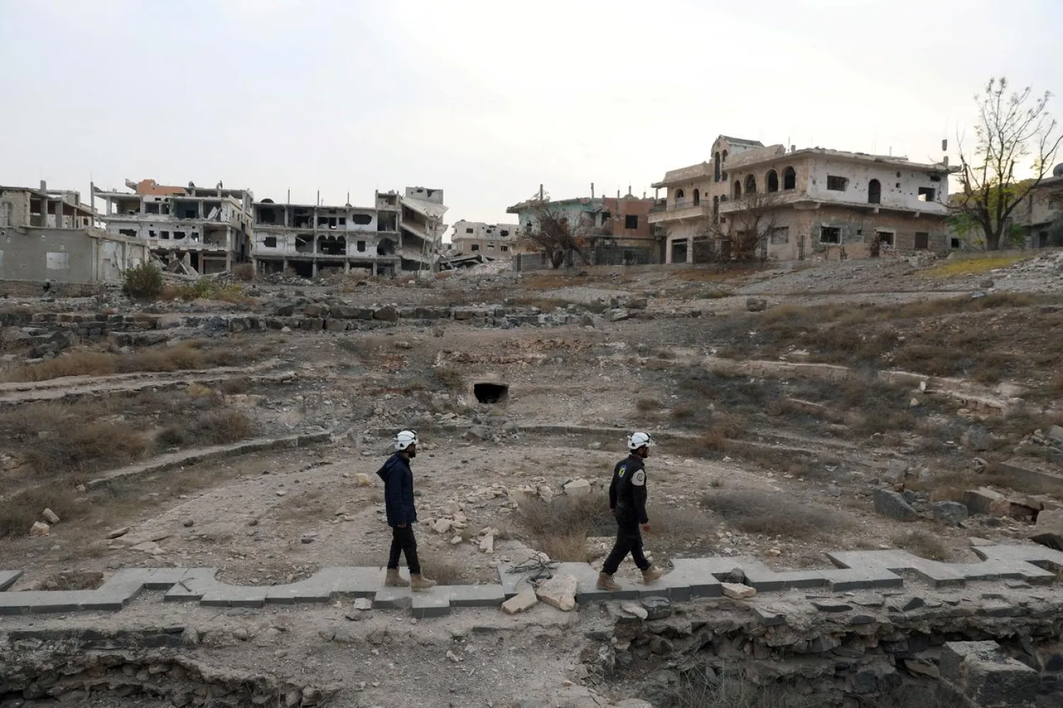 Members of the Civil Defense, also known as the White Helmets, are seen inspecting the damage at a Roman ruin site in Daraa, Syria December 23, 2017. (Reuters)