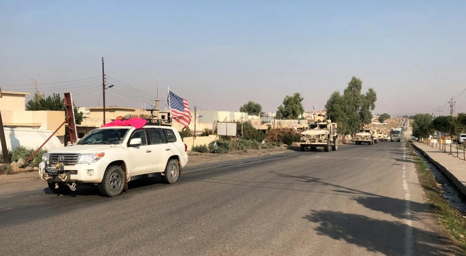 A convoy of US vehicles are seen withdrawing from Syria at the Sahela border crossing with Iraq. (Reuters)