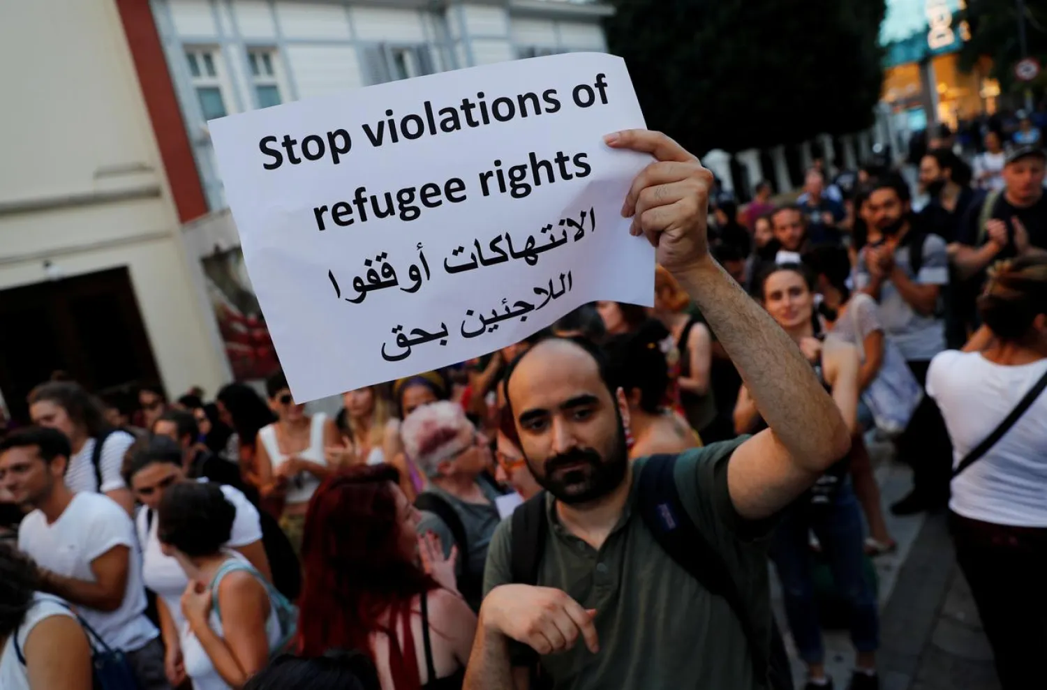 FILE PHOTO: A demonstrator holds a placard during a protest against Turkish government's recent refugee policies in Istanbul, Turkey, August 2, 2019. REUTERS/Murad Sezer