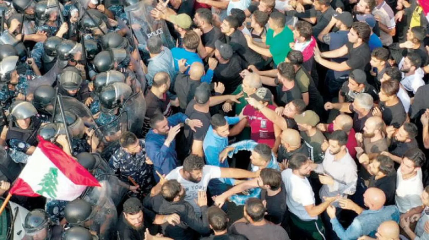 Lebanese riot policemen clashing with Hezbollah supporters during a protest near the government palace, in downtown Beirut, Lebanon, Friday, Oct. 25, 2019. (AP Photo/Hussein Malla)