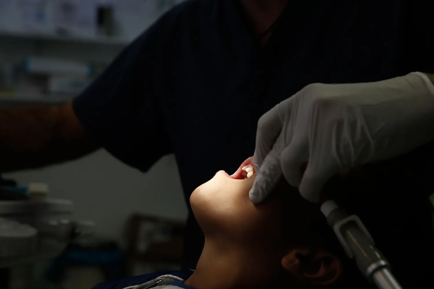 File photo: Dentist Christos Naoumis treats a young boy at a Doctors of the World clinic in central Athens. REUTERS/Alkis Konstantinidis
