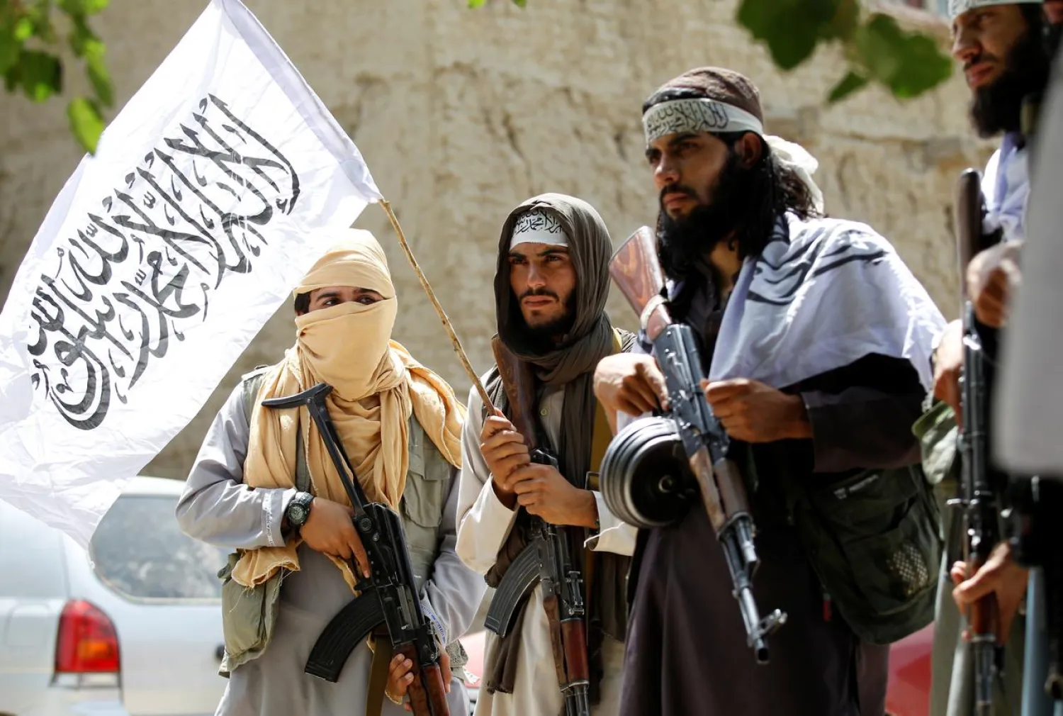 FILE PHOTO: Taliban walk as they celebrate ceasefire in Ghanikhel district of Nangarhar province, Afghanistan June 16, 2018.REUTERS/Parwiz
