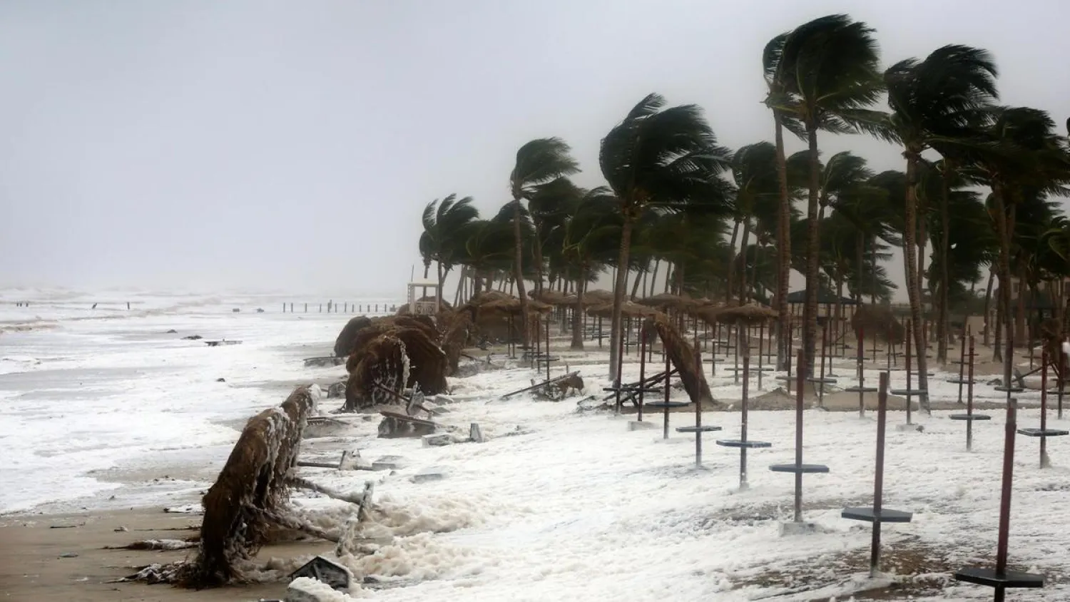 Debris and sea foam litters a beach hit by Cyclone Mekunu in Salalah, Oman, on May 26, 2018. (AP)