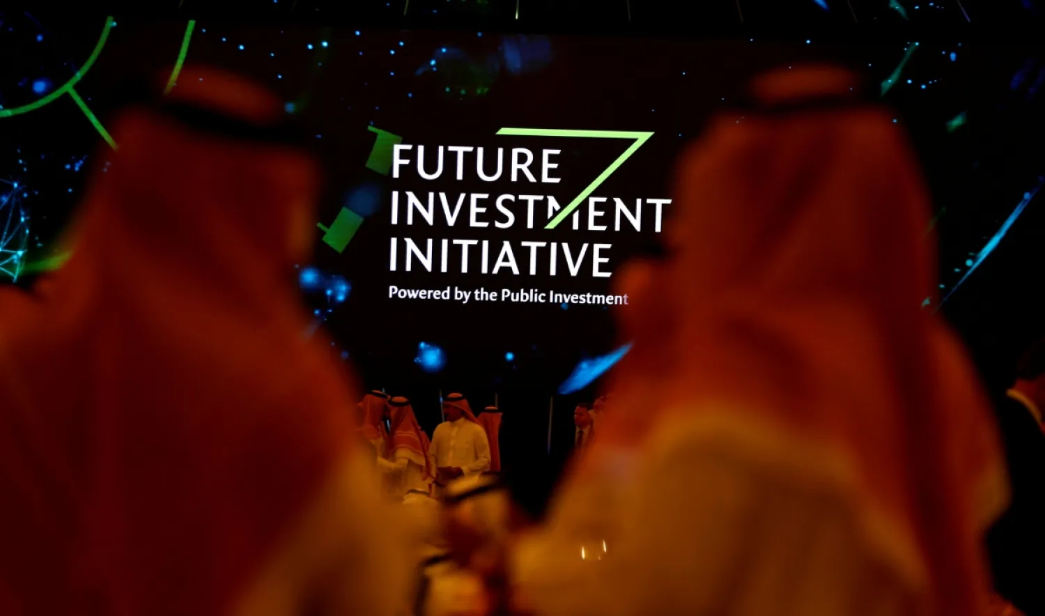 Participants look at a sign of the Future Investment Initiative during the investment conference in Riyadh, Saudi Arabia, on Oct. 23, 2018. (Reuters)