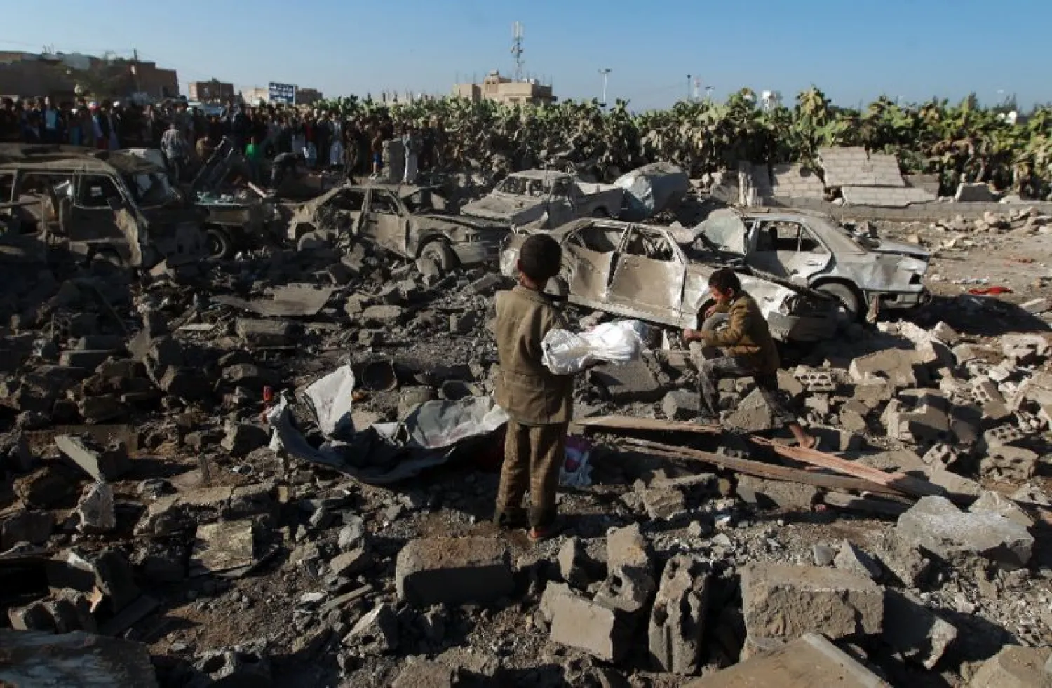 Yemenis stand at the site of an airstrike against Houthis near Sanaa Airport(File photo: AFP)
