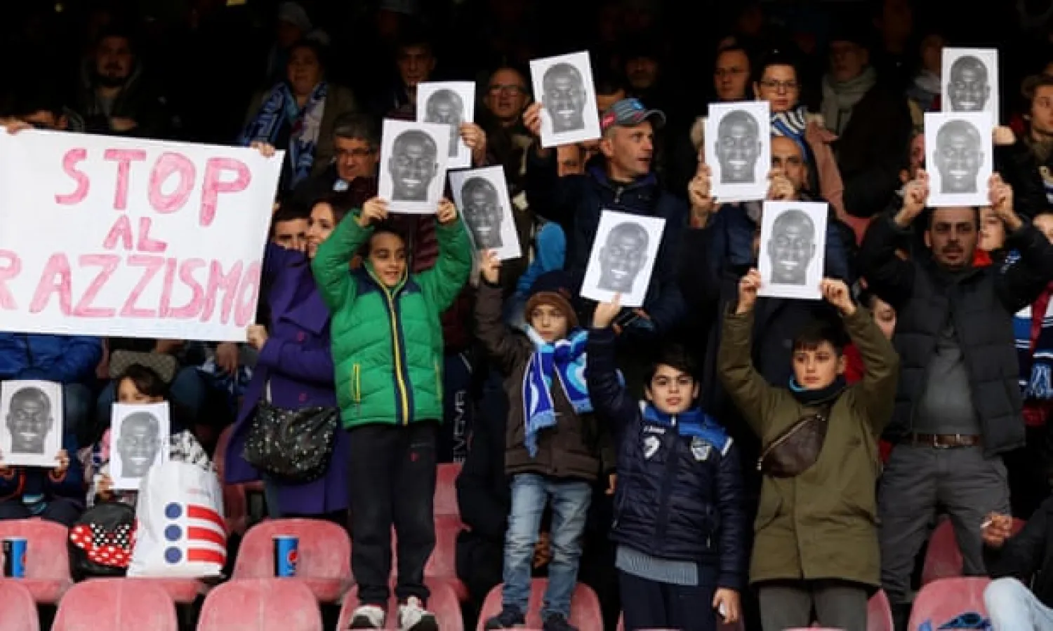  Napoli fans hold up photographs and a banner in support of Kalidou Koulibaly after the Senegalese defender was racially abused in December 2018. Photograph: Cesare Abbate/AP
