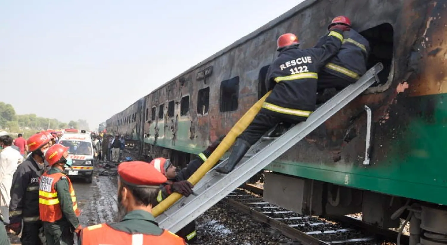 Rescue workers look for survivors following a train damaged by a fire in Liaquatpur, Pakistan, Thursday, Oct. 31, 2019. A massive fire engulfed three carriages of the train traveling in the country's eastern Punjab province (AP Photo/Siddique Baluch)