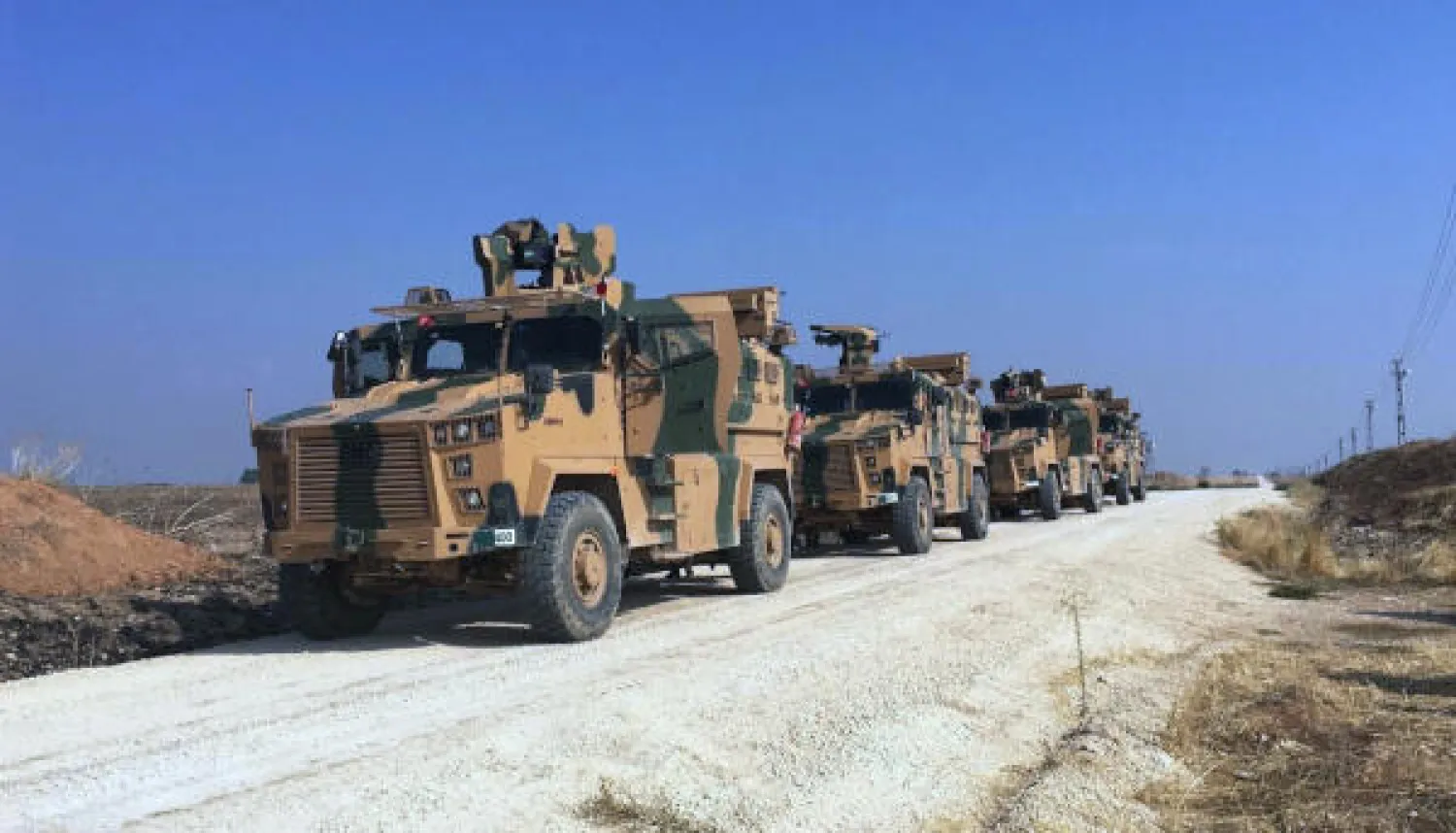 Turkish army's armoured vehicles wait as Turkish and Russian military officials speak at the Turkey-Syria border near Kiziltepe, Mardin province, Turkey, Friday, Nov. 1, 2019. AP
