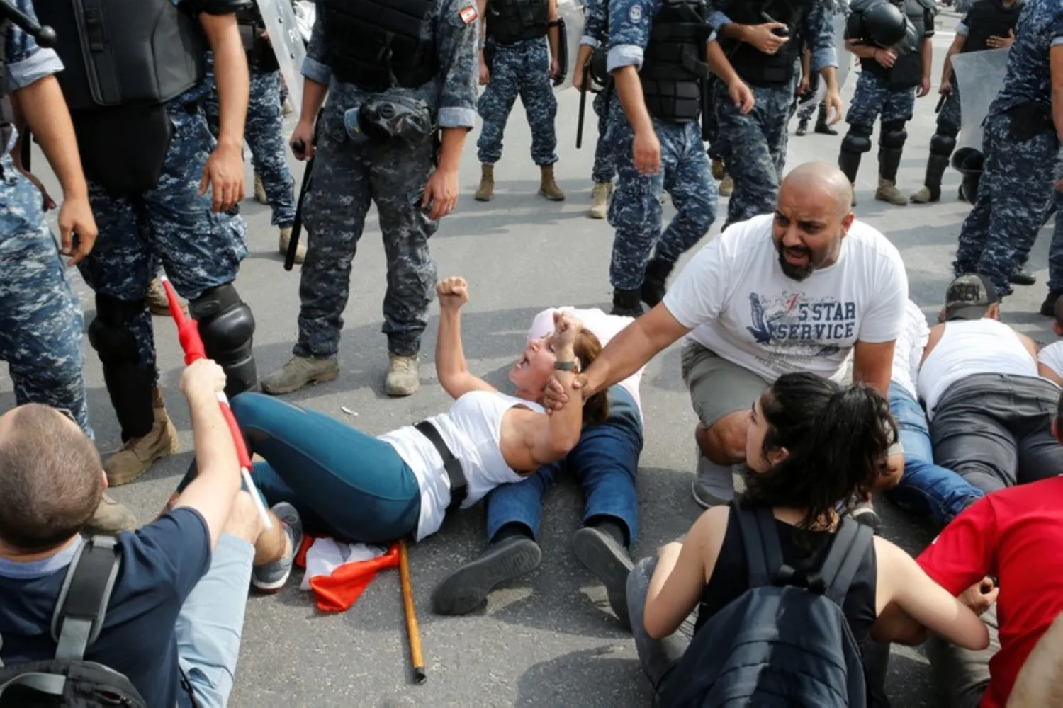 A demonstrator reacts during a police operation to open a blocked highway during anti-government protests in Beirut, Lebanon, October 26, 2019. REUTERS/Mohamed Azakir