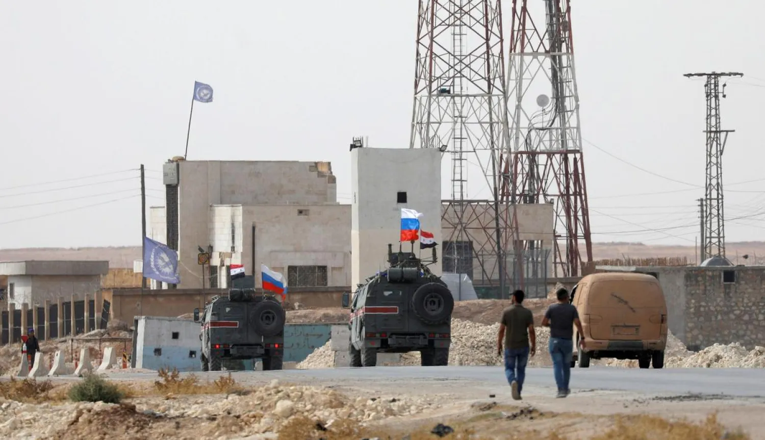 FILE PHOTO: Russian and Syrian national flags flutter on military vehicles near Manbij, Syria, October 15, 2019. REUTERS/Omar Sanadiki/File Photo