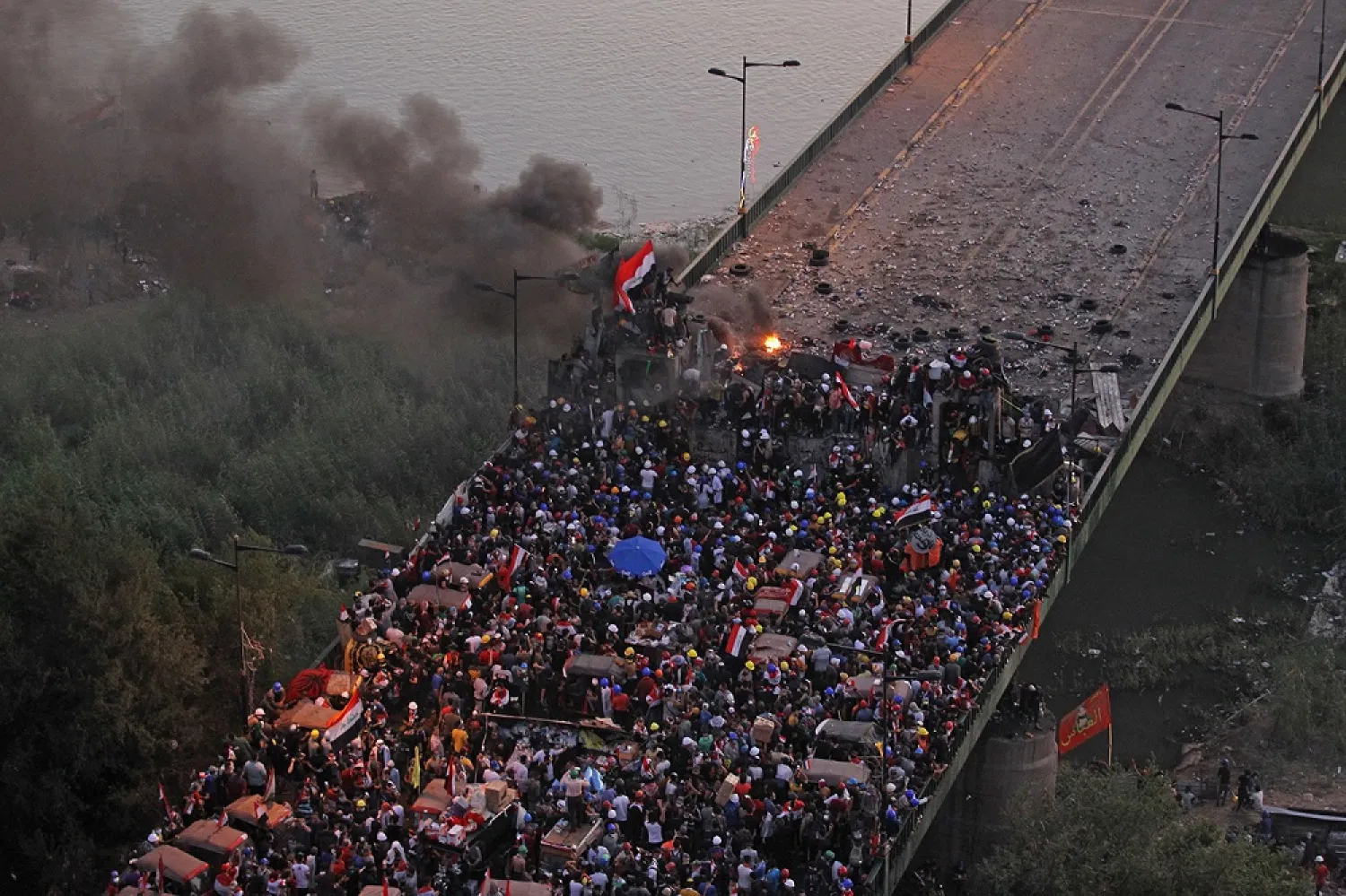 Iraqi protesters gather on Al-Joumhouriyah Bridge, which leads to the high-security Green Zone, during ongoing anti-government demonstrations in Baghdad on October 31. (Getty Images)