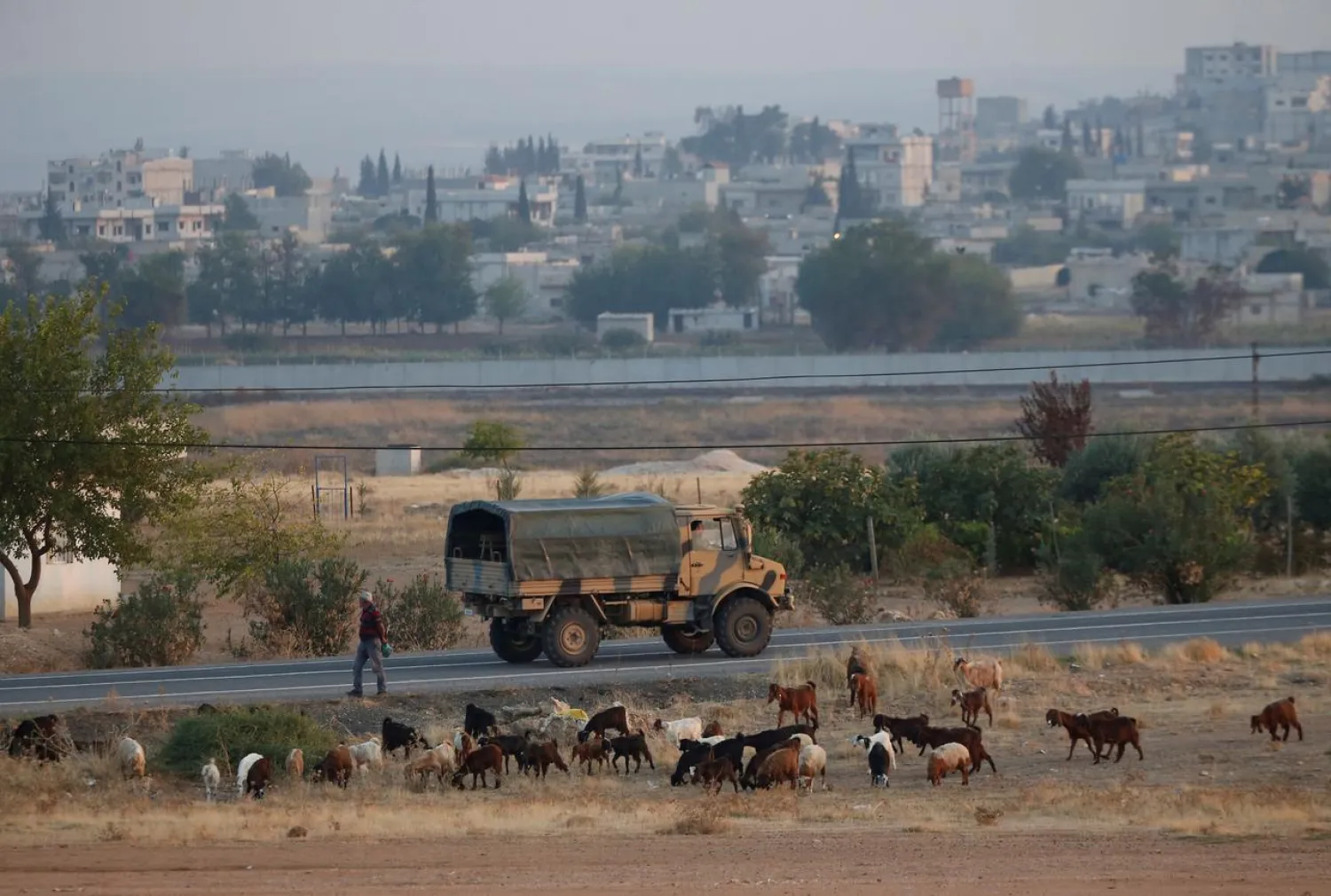 A Turkish military truck drives on the Turkish-Syrian border, with the Syrian town of Kobani in the background, in Suruc, in Sanliurfa province, Turkey, October 31, 2019. (Reuters)