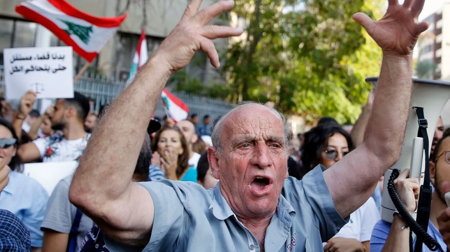 An anti-government protester chants slogans during ongoing protests against the Lebanese government, in front of the Justice Palace in Beirut, Lebanon, Wednesday, Nov. 6, 2019. (AP)