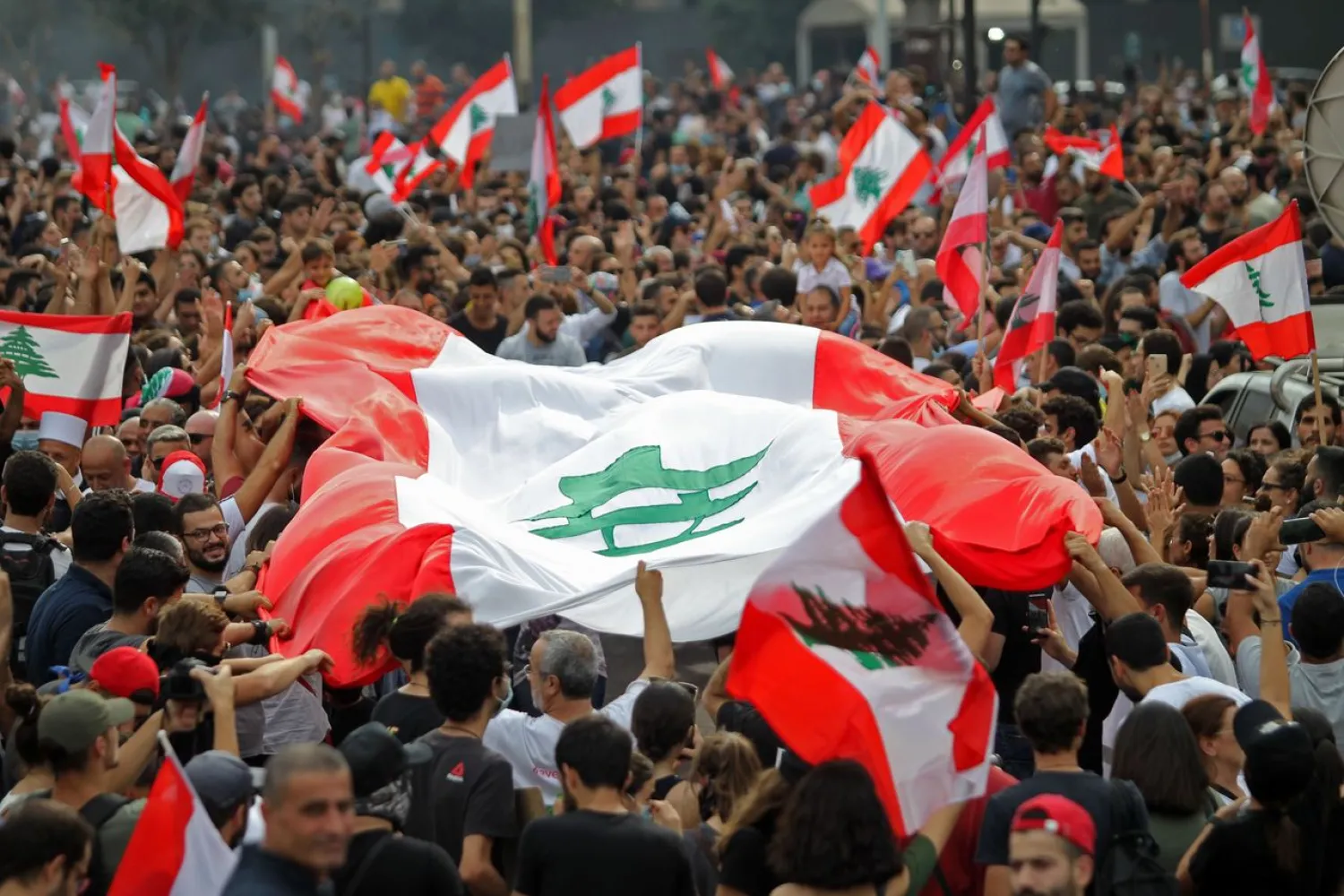 Lebanese demonstrators wave the national flag during a protest against dire economic conditions in downtown Beirut on Oct. 18, 2019. (Getty Images)