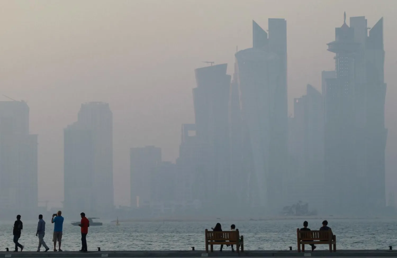 People sit on the corniche in Doha, Qatar, June 15, 2017. (Reuters)