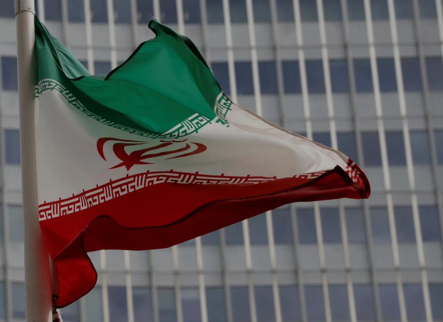 FILE PHOTO: An Iranian flag flutters in front of the International Atomic Energy Agency (IAEA) headquarters in Vienna, Austria September 9, 2019. REUTERS/Leonhard Foeger/File Photo