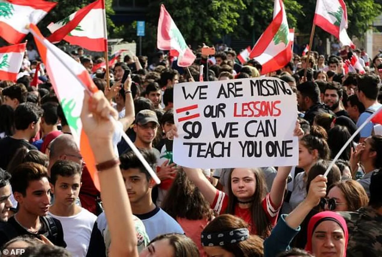 Students and schoolchildren have joined the mass protests in Lebanese cities demanding better public education and more job opportunities for school leavers - AFP