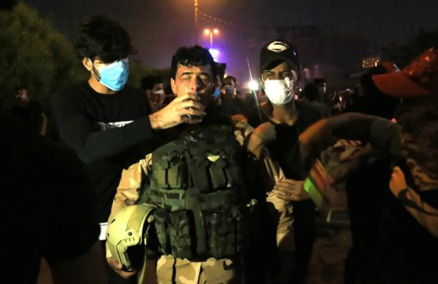An Iraqi soldier is comforted by demonstrators during anti-government protests inf Karbala, south of Iraq's capital Baghdad, late on October 28, 2019. AFP