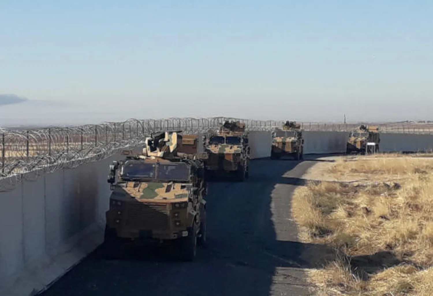 Turkish army armoured vehicles arrive near the Turkish town of Idil at the Turkey-Syria border before Turkish and Russian troops conduct their third joint patrols in northeast Syria, Friday, Nov. 8, 2019. AP