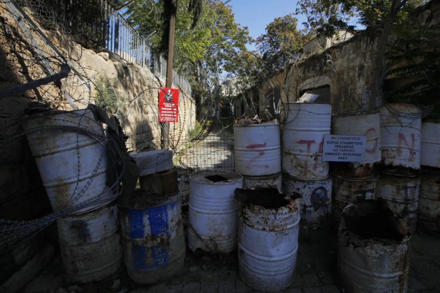 In this photo taken on Nov. 7, 2019, a Turkish military sign is seen behind barrels that block a road from the Greek Cypriot south to the Turkish Cypriots north in divided capital Nicosia, Cyprus. (AP)