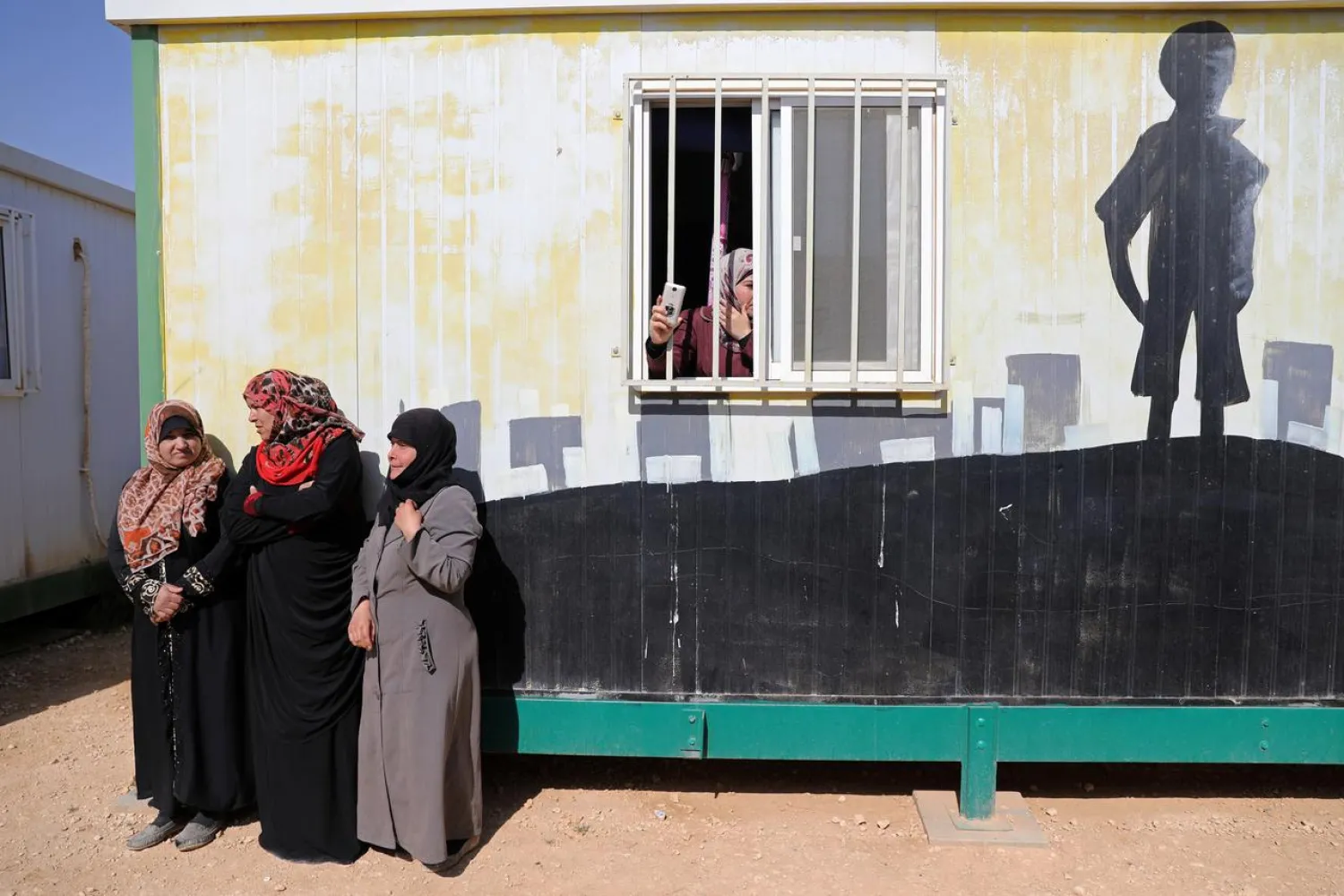 Syrian refugees stand in Al Zaatari refugee camp near Mafraq, Jordan near the border with Syria March 28, 2017. REUTERS/Ammar Awad