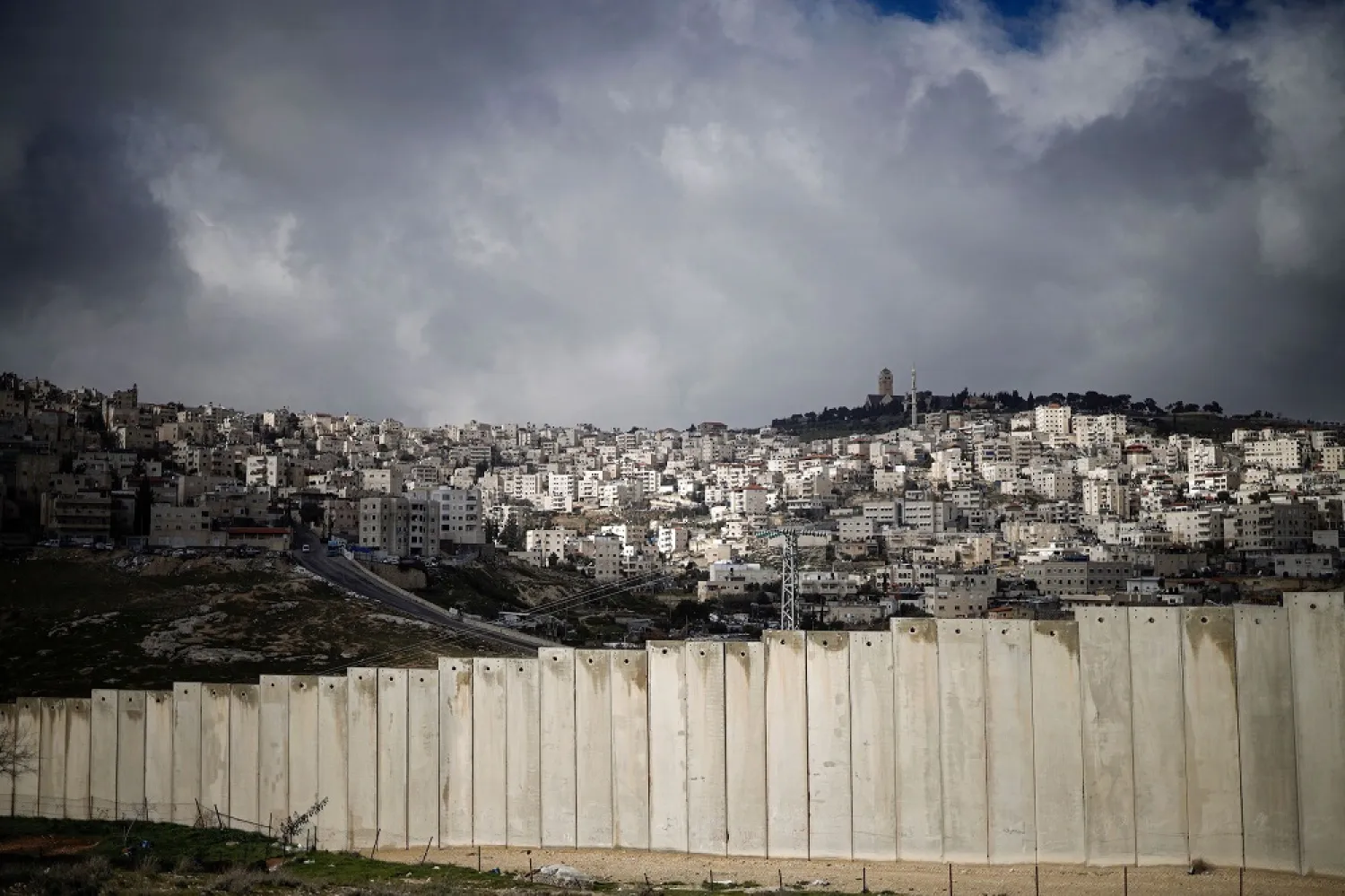 This picture taken on Jan. 17, 2019, shows the barrier separating the Palestinian West Bank village of Eizariya (foreground) and Jerusalem (background). (Getty Images)