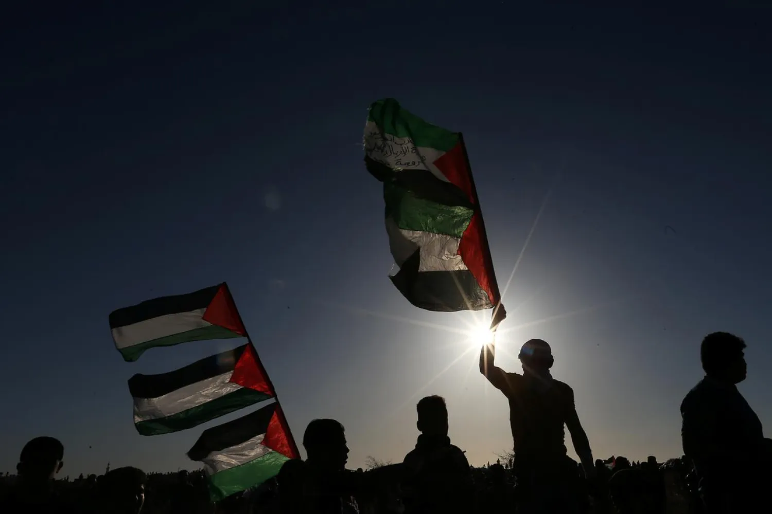 Demonstrators hold Palestinian flags during a protest at the Israel-Gaza border fence, in the southern Gaza Strip May 3, 2019. (Reuters)