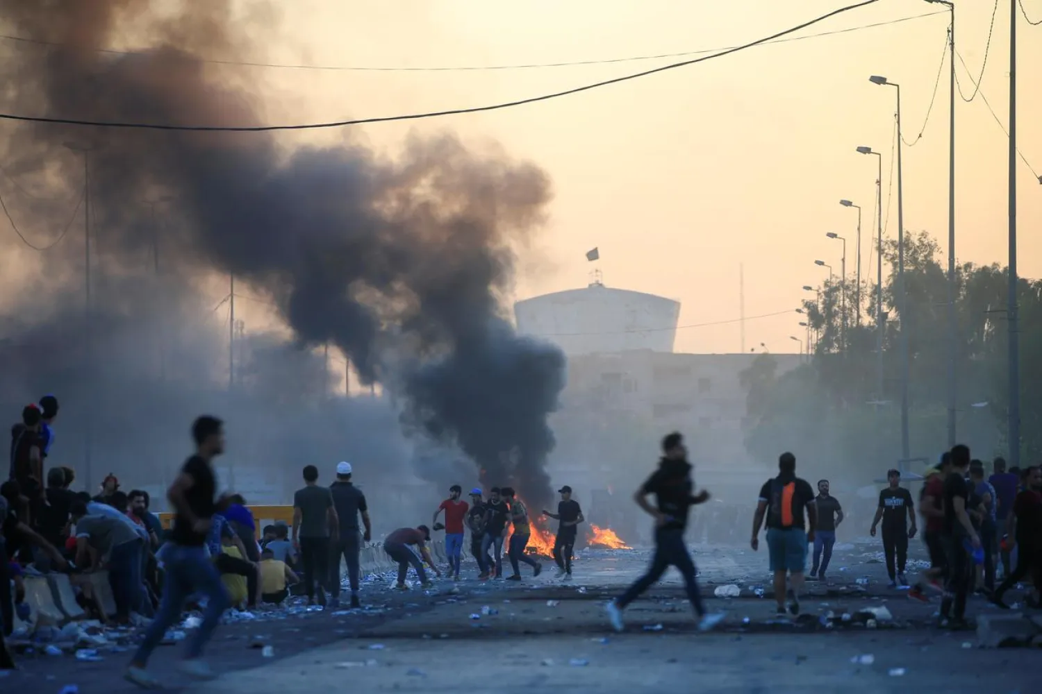 Demonstrators gather at a protest during a curfew, three days after the nationwide anti-government protests turned violent, in Baghdad, Iraq (File Photo: Reuters)
