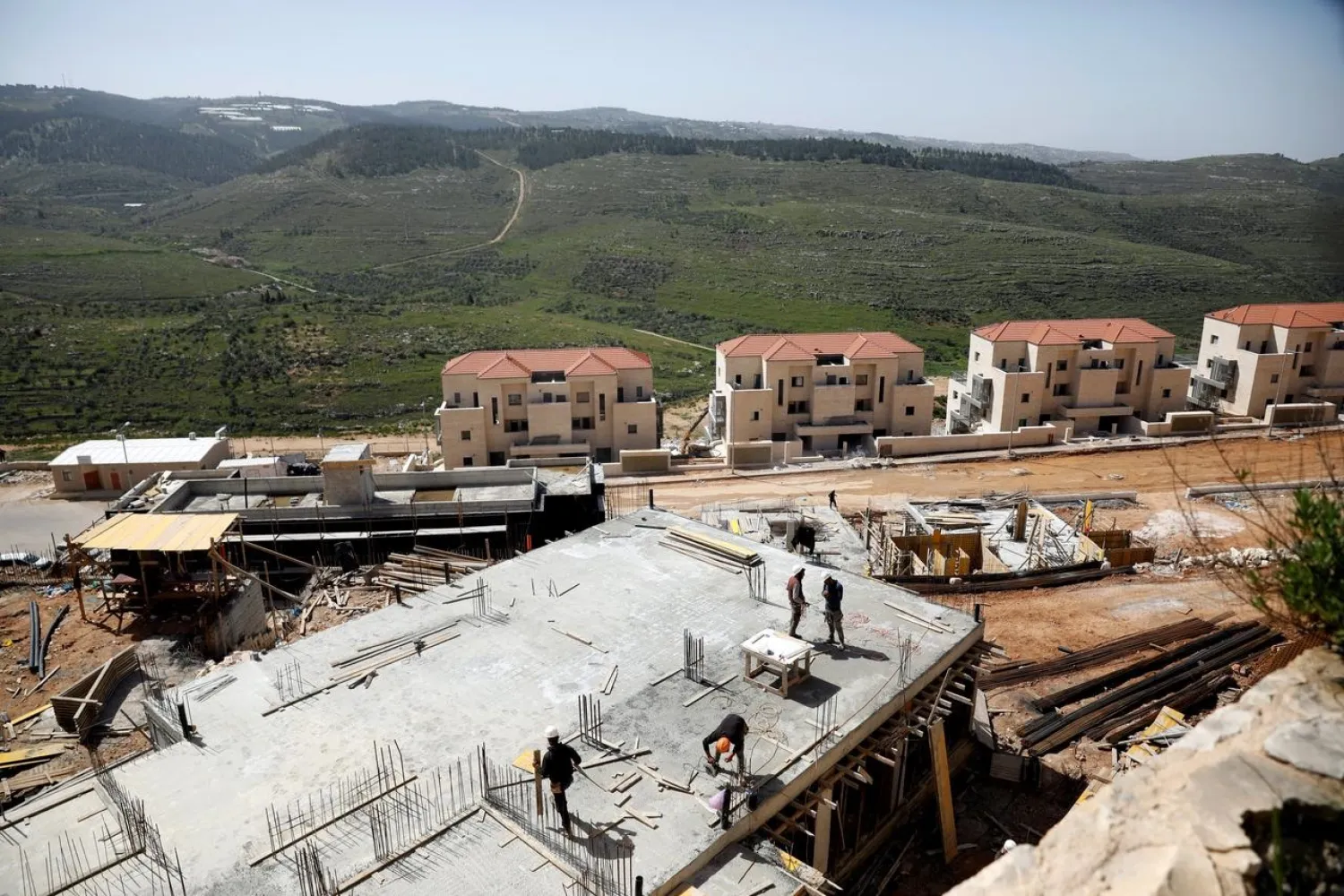 Laborers work at a construction site in the Israeli settlement of Beitar Illit in the Israeli-occupied West Bank April 7, 2019. (Reuters)