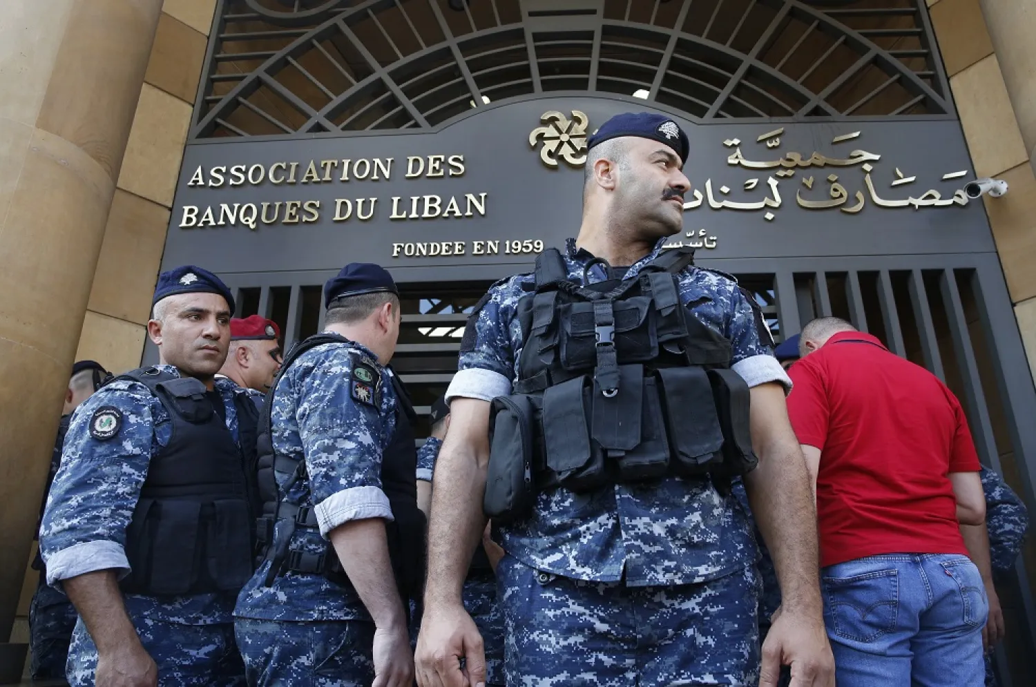 Police stand guard outside the Lebanese Association of Banks after protesters locked the main entrance during ongoing protests against the banks and the government, in Beirut, Lebanon, Nov. 1, 2019. (AP)