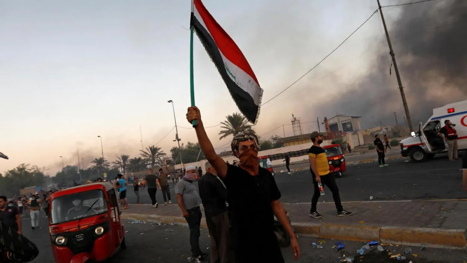 A protesters holds up the Iraqi flag during an anti-government demonstration in Baghdad on October 5, 2019. (Reuters)
