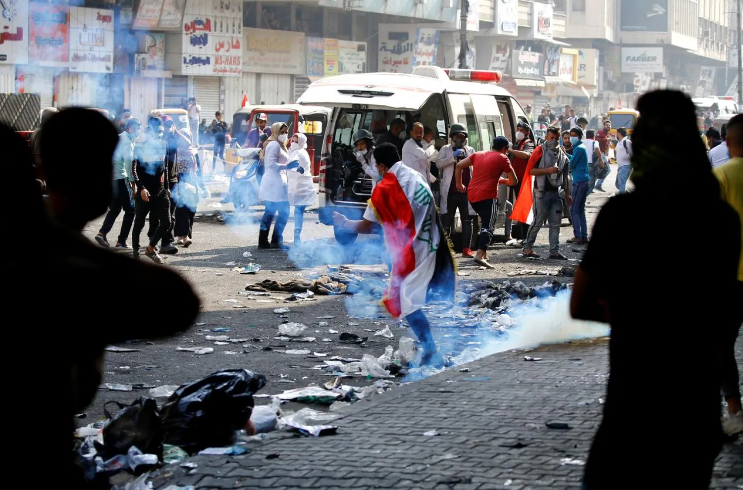 Demonstrators run from tear gas thrown by Iraqi security forces during the ongoing anti-government protests in Baghdad, Iraq November 12, 2019. (Reuters)