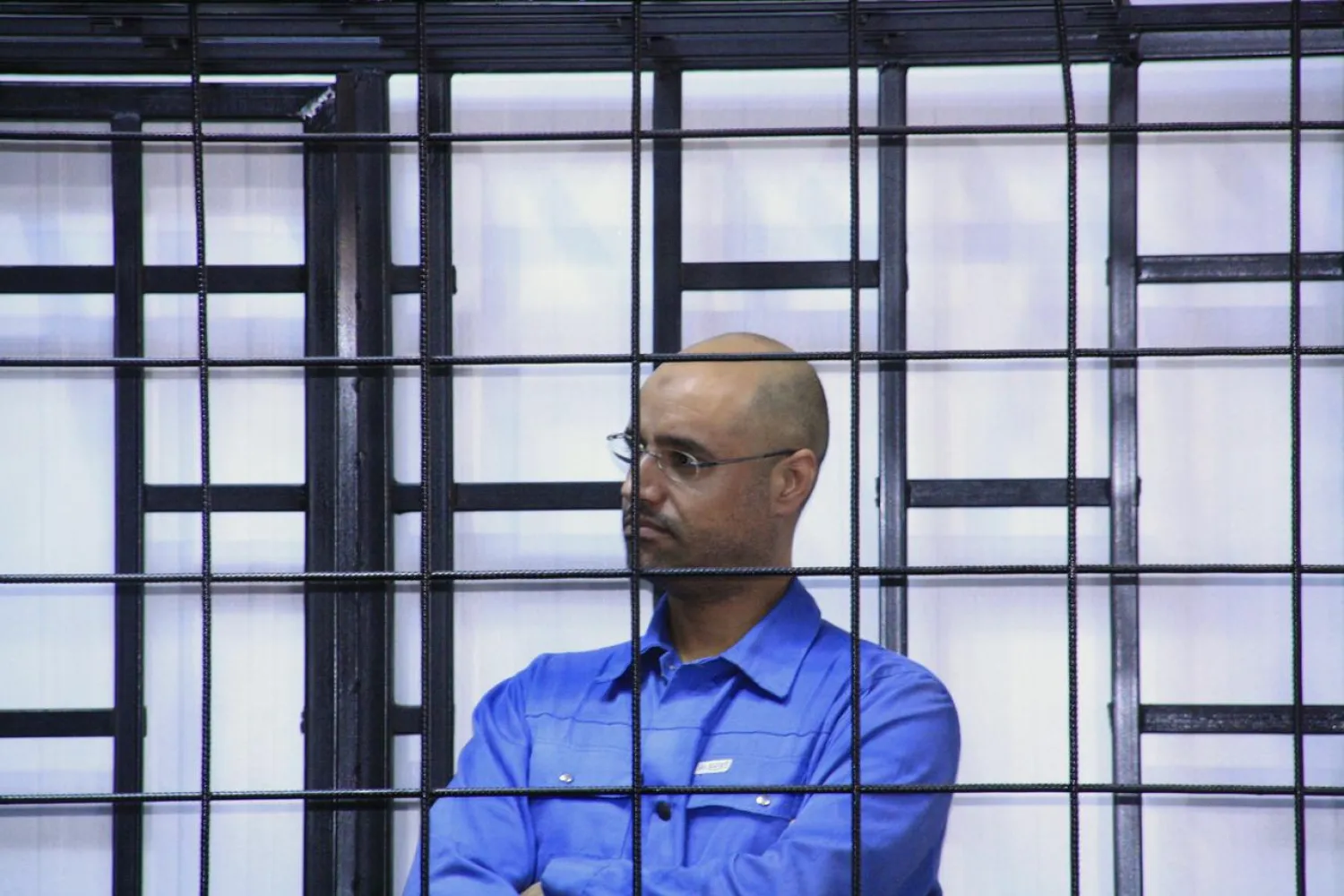 Saif al-Islam al-Gaddafi attends a hearing behind bars in a courtroom in Zintan May 25, 2014. (Reuters)