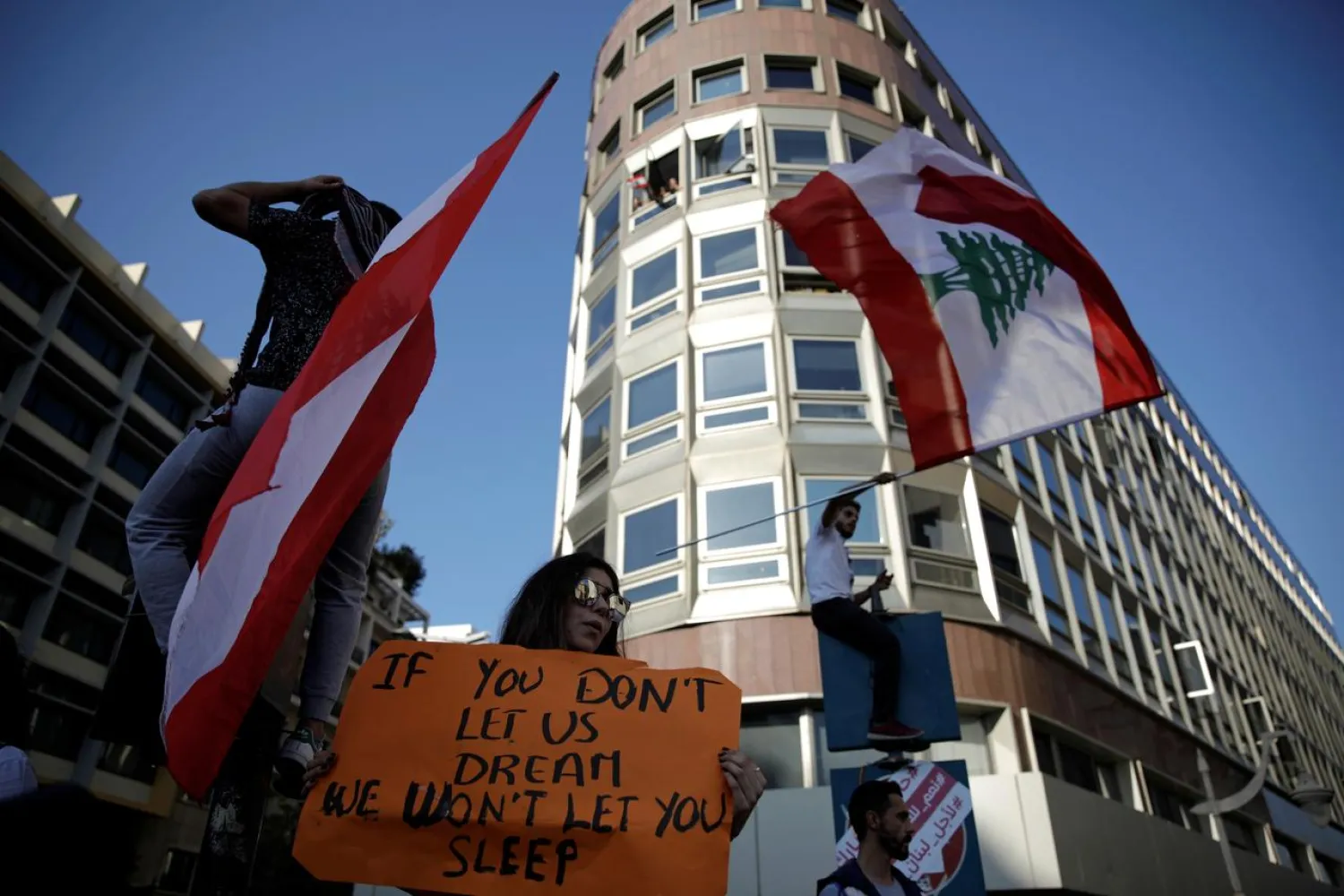 Protesters wave flags at a demonstration organized by students during ongoing anti-government protests in Beirut, Lebanon November 12, 2019. REUTERS/Andres Martinez Casares