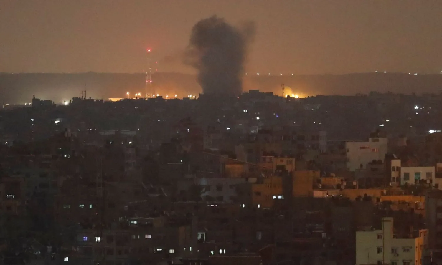 An explosion caused by Israeli airstrikes is seen in Gaza City, early Thursday, Nov. 14, 2019. (AP Photo/Adel Hana)