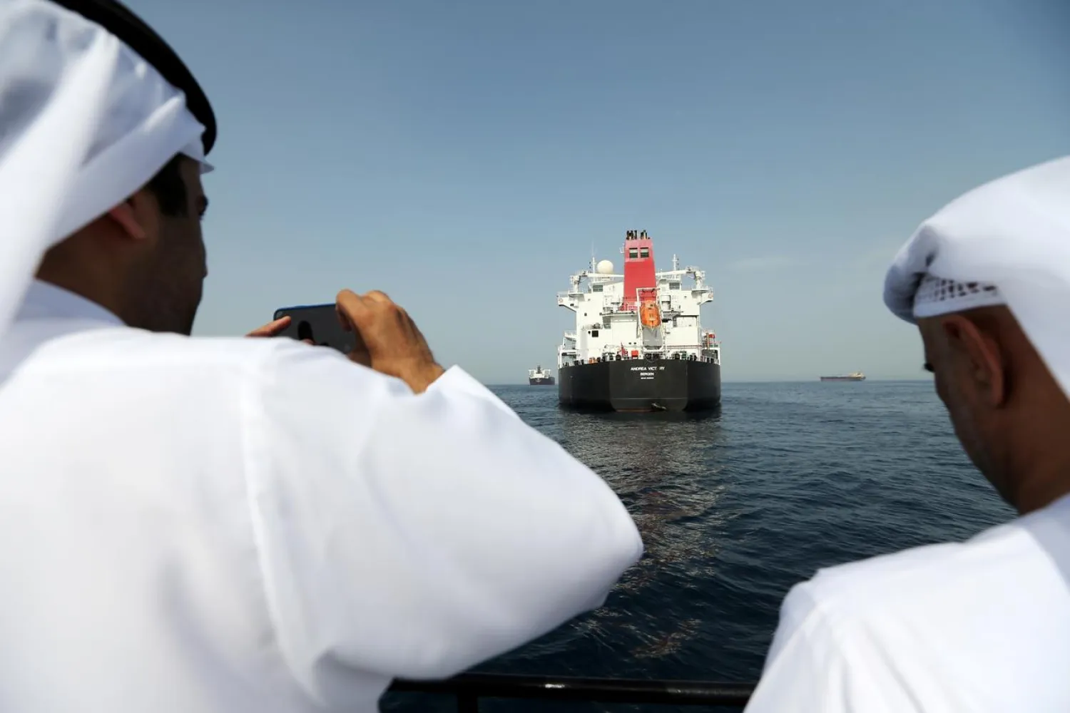 Port officials take a photo of the damaged tanker Andrea Victory at the Port of Fujairah, United Arab Emirates, May 13, 2019. REUTERS/Satish Kumar/File Photo