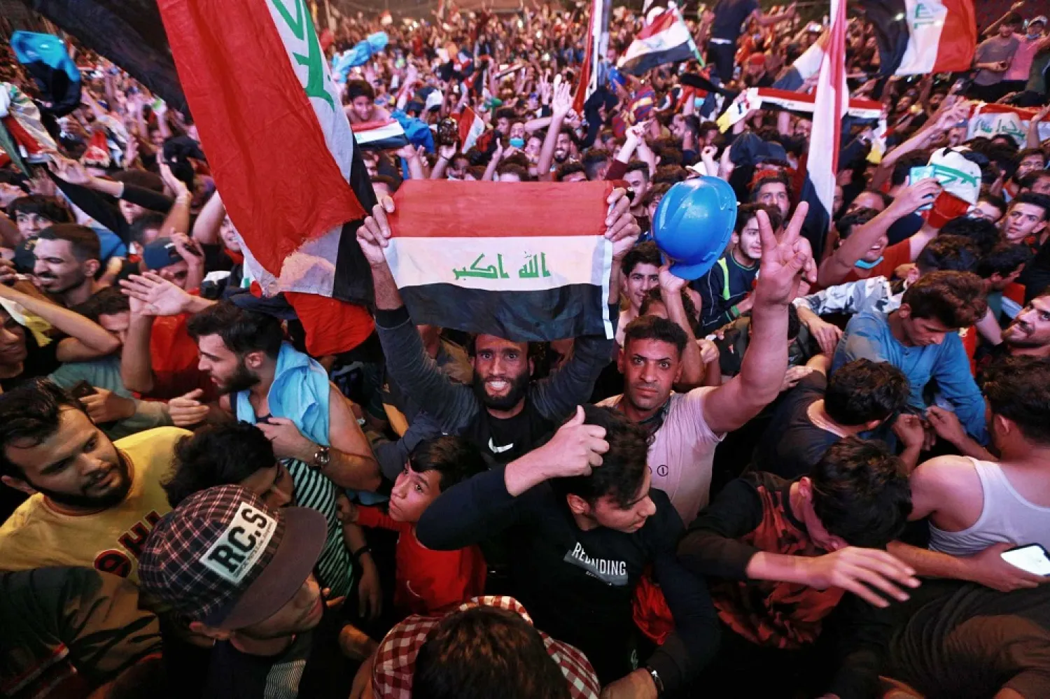 Anti-government protesters celebrate a football match win against Iran during a World Cup qualifier, Baghdad, Iraq, Thursday, November 14, 2019. (AP)