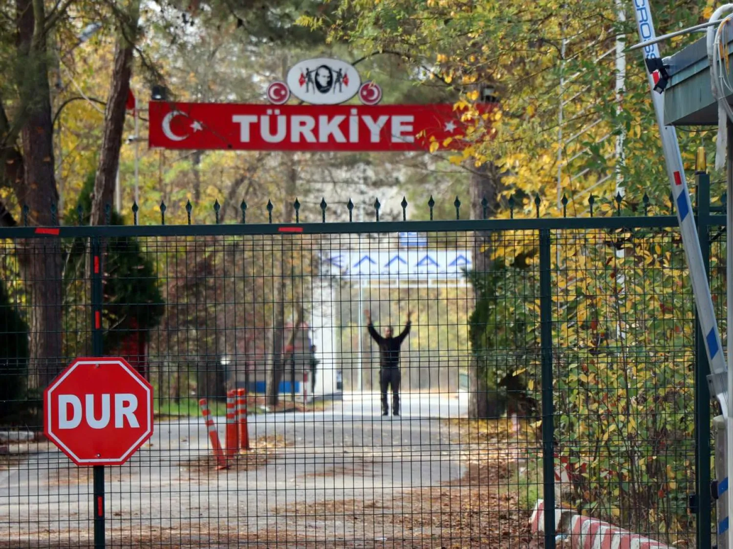 The US citizen, who was deported by Turkey, stands on the no-man's land between Turkey and Greece, as he is pictured from the Pazarkule border crossing near Edirne, Turkey, November 11, 2019. Ali Can Zeray/Demiroren News Agency (DHA) via REUTERS