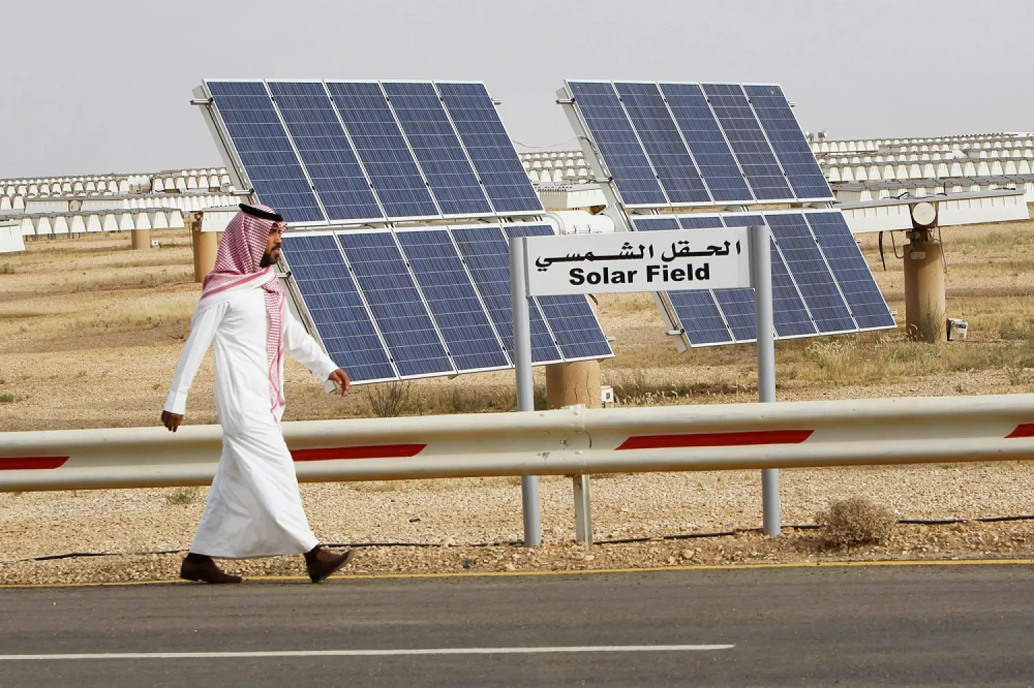 A Saudi man walks past a field of solar panels at the King Abdulaziz city of Sciences and Technology, Al-Oyeynah Research Station, in Saudi Arabia. (Reuters)