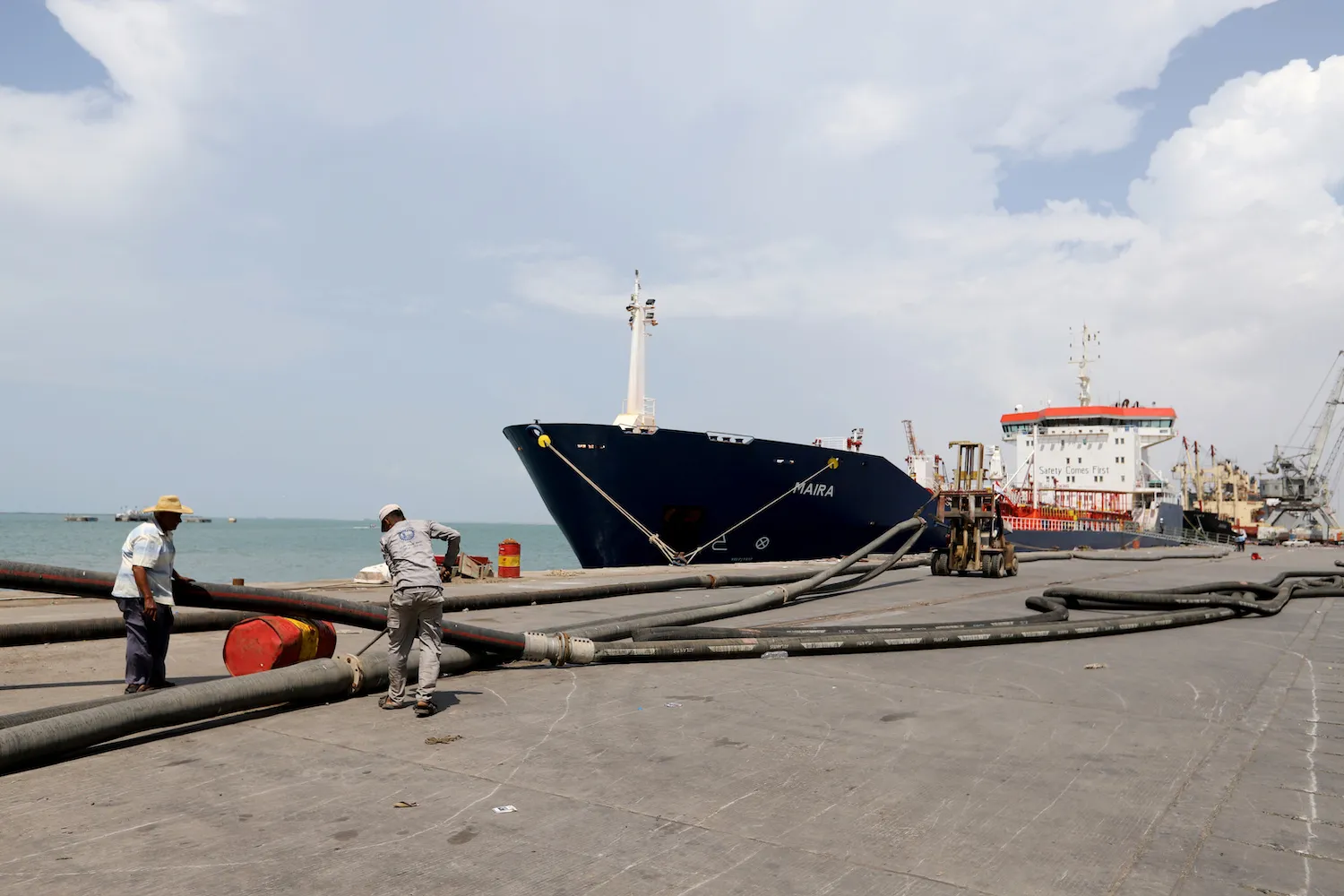 Workers prepare to unload a fuel shipment from an oil tanker at the port of Hodeidah, Yemen October 17, 2019. (Reuters)