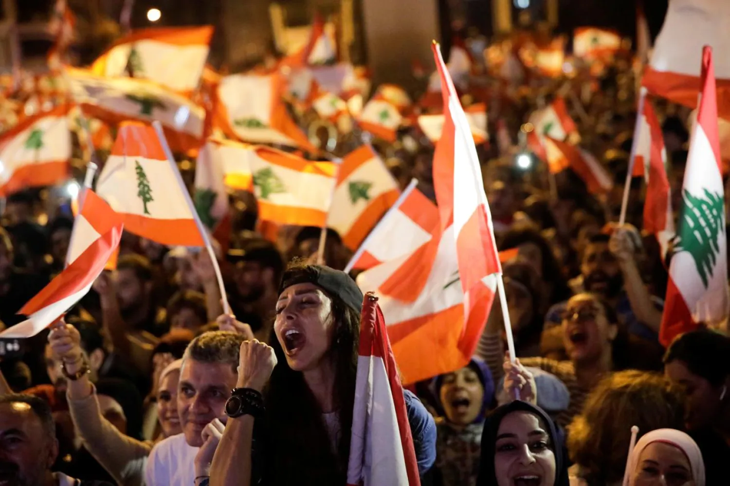 Protesters chant slogans and wave Lebanese flags during a demonstration at Martyrs' Square during ongoing anti-government protests in Beirut, Lebanon November 10, 2019. (Reuters)