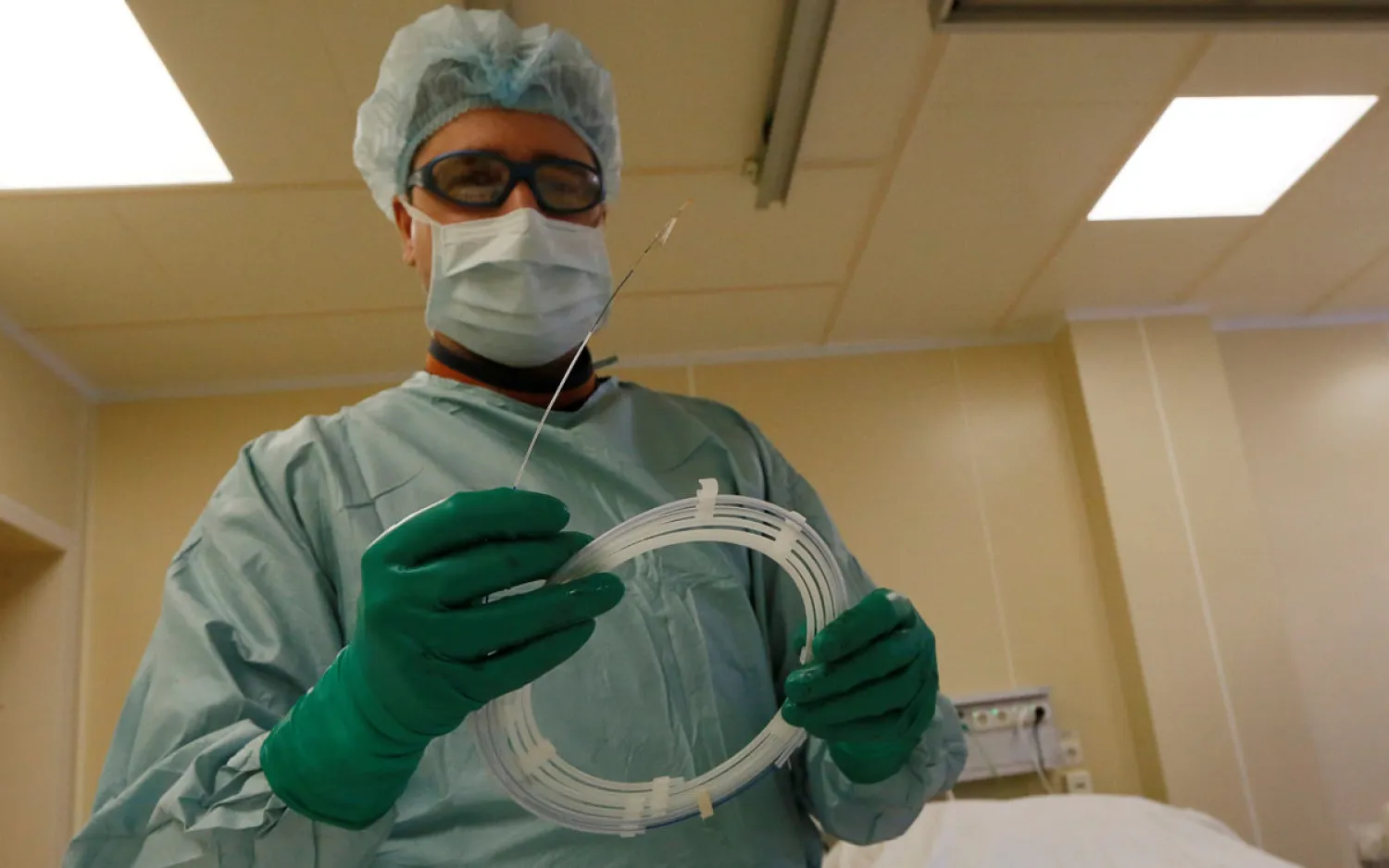 A heart surgeon holds a stent, which is inserted into constricted coronary arteries to help keep them open and normalize blood flow. (Reuters)