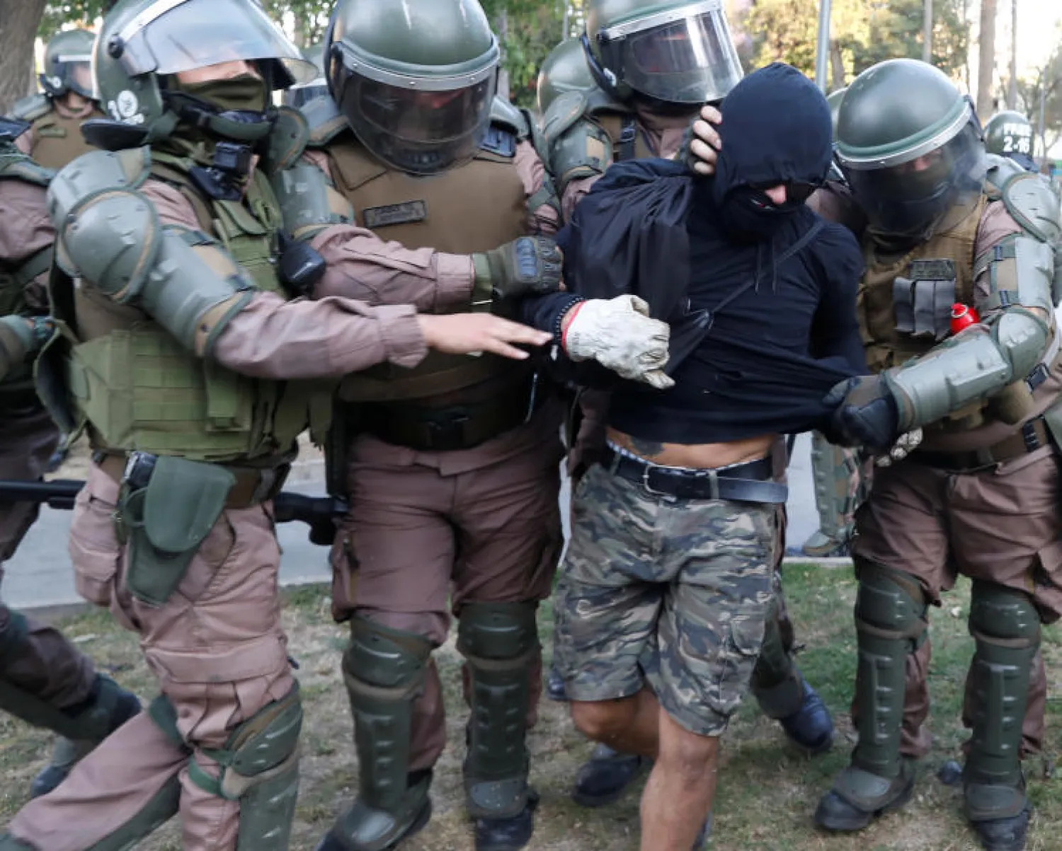 قوات الأمن التشيلية تحتجز أحد المتظاهرين (رويترز)