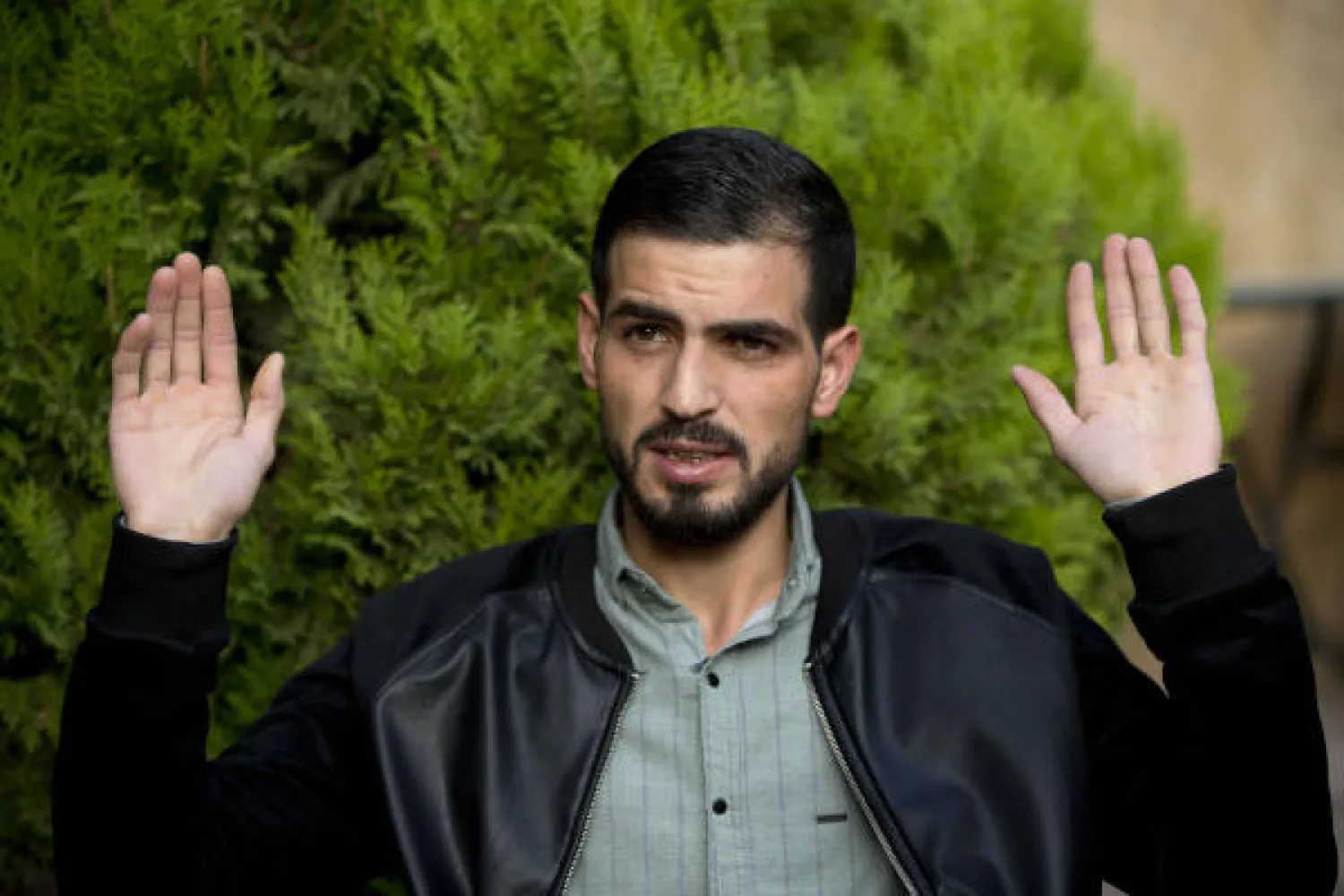 Palestinian Karam Qawasmi, who was shot in the back by Israeli forces in an incident caught on video last year, gestures as he gives an interview in the West Bank city of Hebron, Sunday, Nov. 10, 2019. AP