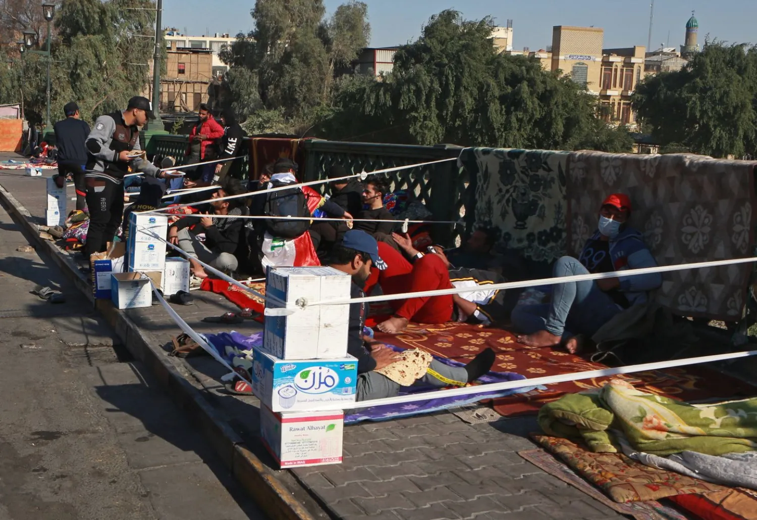 Anti-government protesters stage a sit-in on the Ahrar Bridge, in Baghdad, Iraq, Wednesday, Nov. 20, 2019. (Khalid Mohammed/Associated Press)