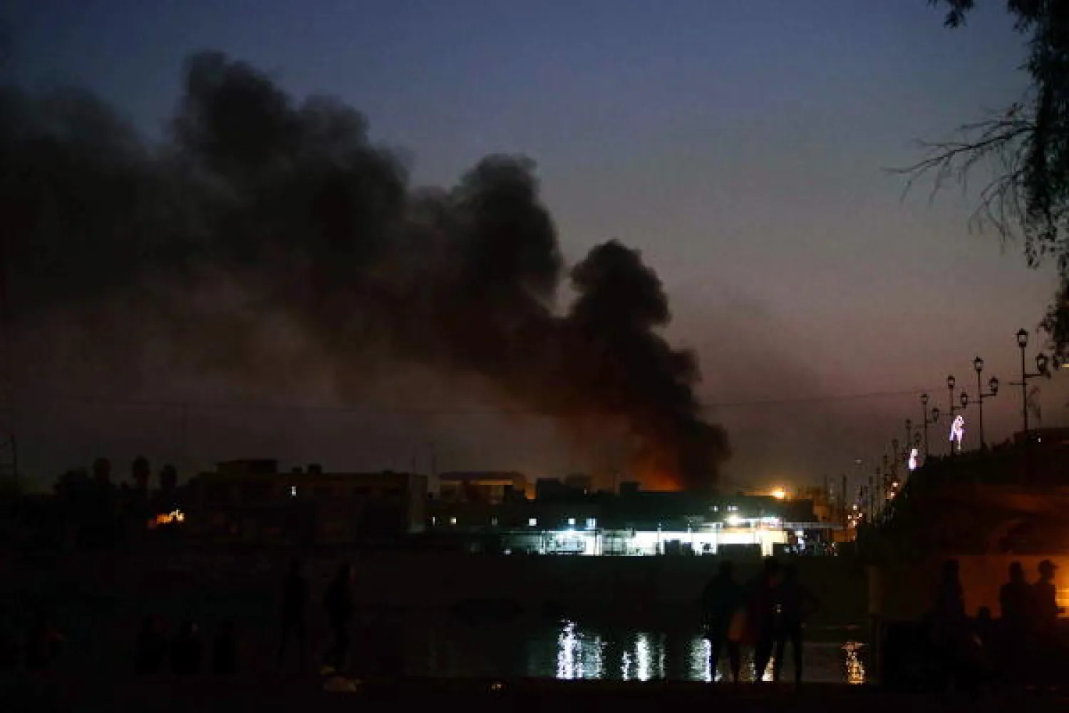 Smoke clouds rise from the site of clashes between Iraqi protesters and security forces near al-Ahrar bridge (The Freemen Bridge) in central Baghdad, Iraq, 04 November 2019. EPA