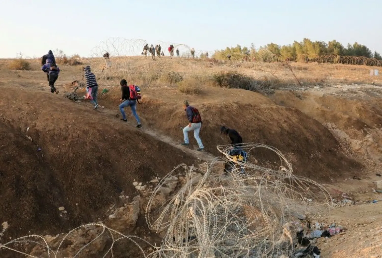 Undocumented Palestinian workers play a cat and mouse game with Israeli security -- sometimes making several attempts before crossing without being spotted | AFP