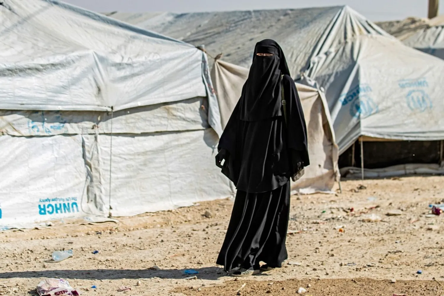 A woman walks at the al-Hol camp in Syria, where families of ISIS foreign fighters are held. (AFP)