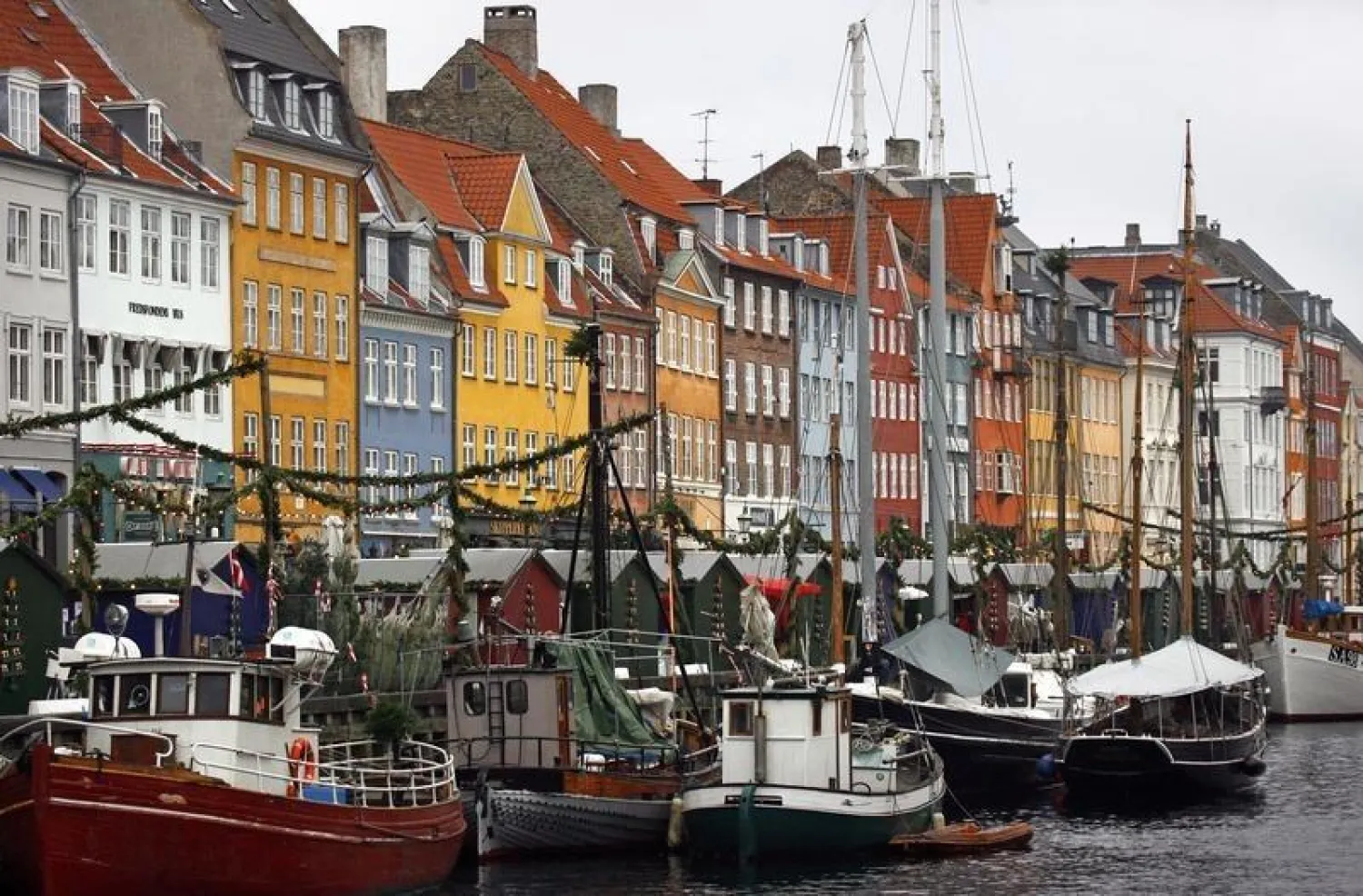 Boats are seen anchored at the 17th century Nyhavn district, home to many shops and restaurants in Copenhagen December 5, 2009. REUTERS/Bob Strong