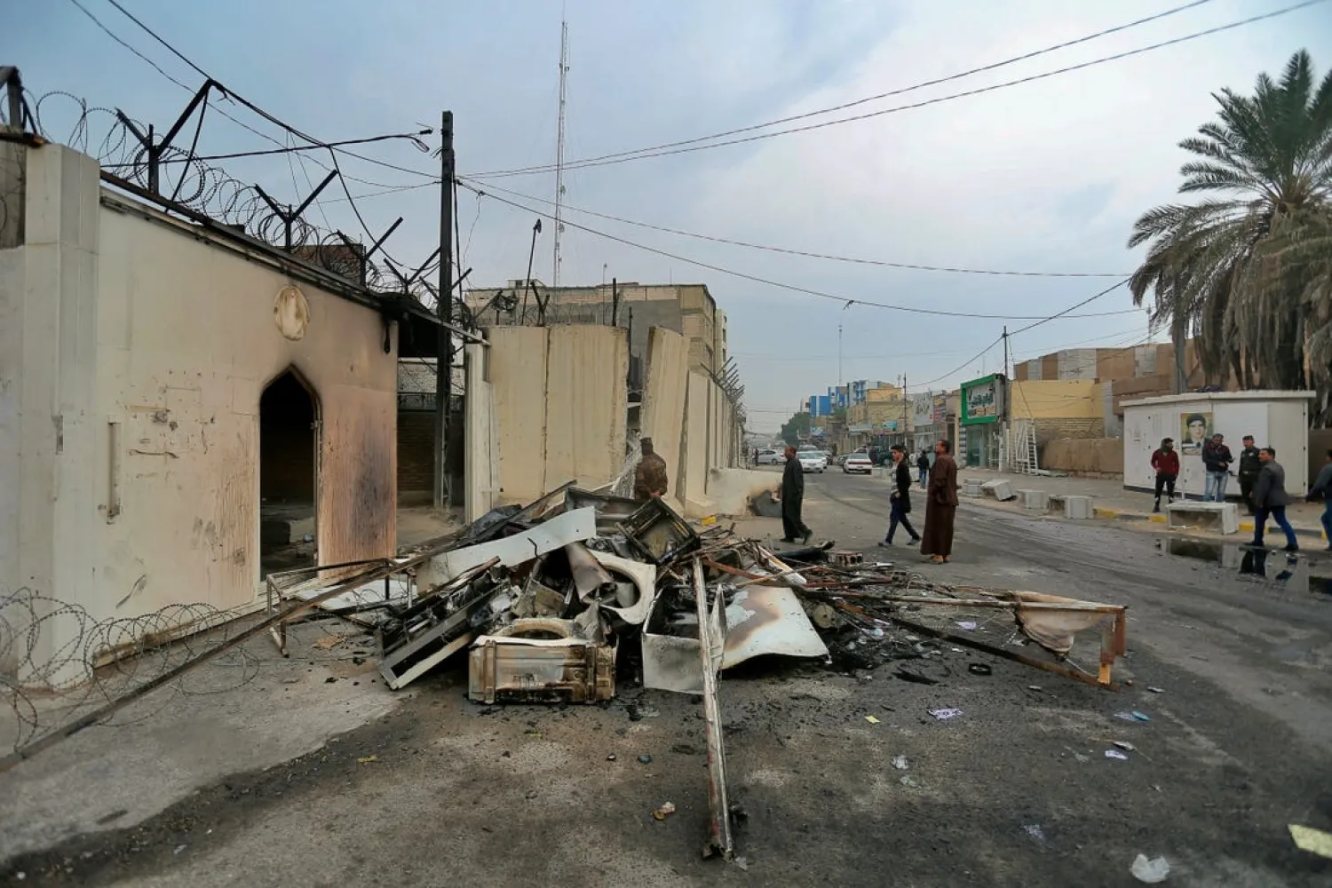 Security forces and civilians gather near the burned Iranian consulate in Najaf, Iraq, Thursday, Nov. 28, 2019. (AP)